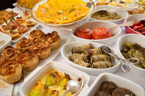 a table with many different dishes of food on it at Hotel Villa Marsili in Cortona