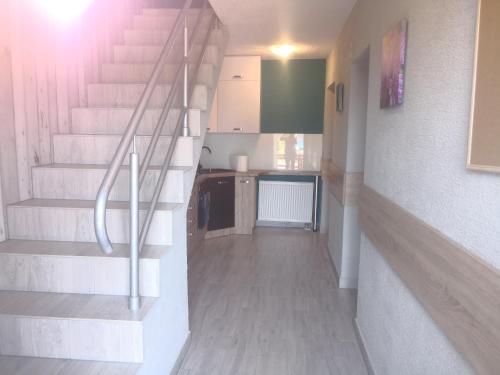 a hallway with stairs and a kitchen in a house at Gościniec Mariola in Człuchów