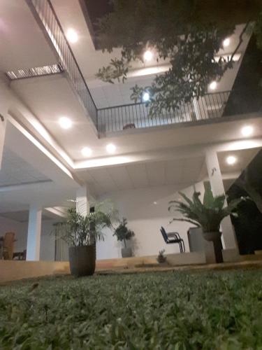 a lobby with a staircase and potted plants at Sudunelum Holiday Resort in Anuradhapura