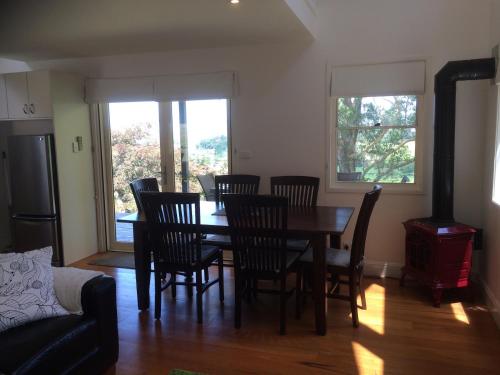 a dining room with a table and chairs at Haven Villa in Berry