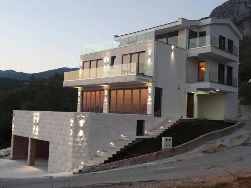 a large white house with a lot of windows at Villa Horus in Sveti Stefan