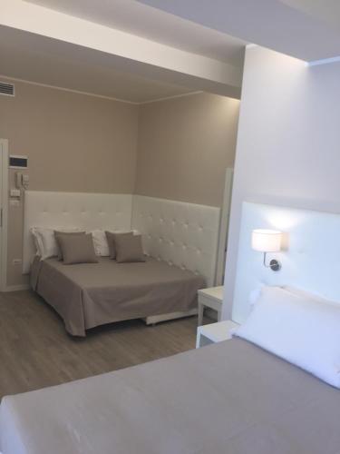 a bedroom with a bed in a room at Hotel Ardea in Riccione