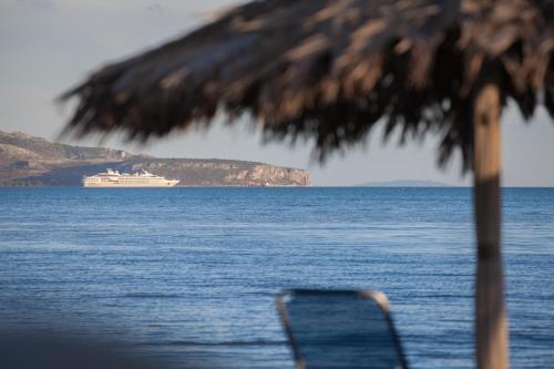 a cruise ship in the water with a chair at Alexandros Boutique Hotel in Nafplio