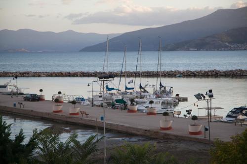 a group of boats docked at a dock in the water at Alexandros Boutique Hotel in Nafplio
