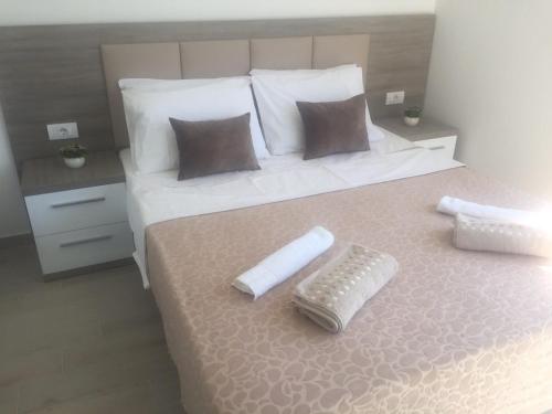 a bedroom with a bed with a remote control on it at Rasi Luxury Apartments in Ulcinj