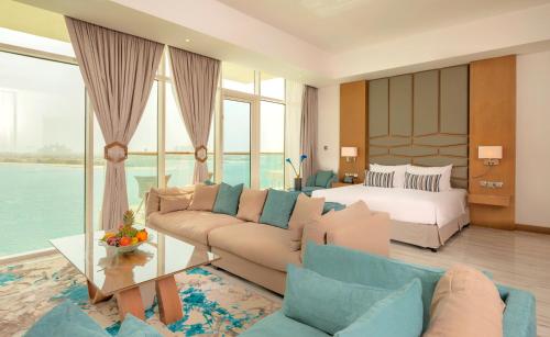 a living room with a bed and a couch and a bedroom at Royal Central Hotel and Resort The Palm in Dubai