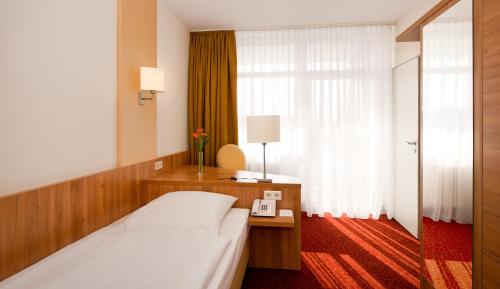 Ένα ή περισσότερα κρεβάτια σε δωμάτιο στο Ringhotel Haus Oberwinter