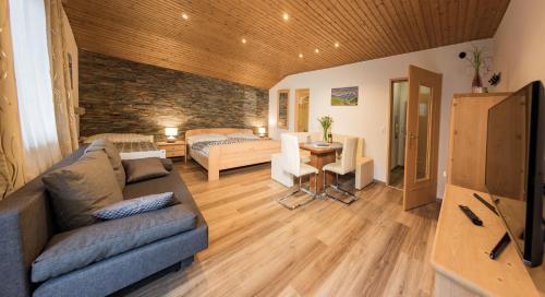 a living room with a couch and a table at Alpenappartements in Bad Gastein