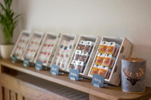 a shelf with a bunch of pastries on a table at Haus Drei Linden in Going