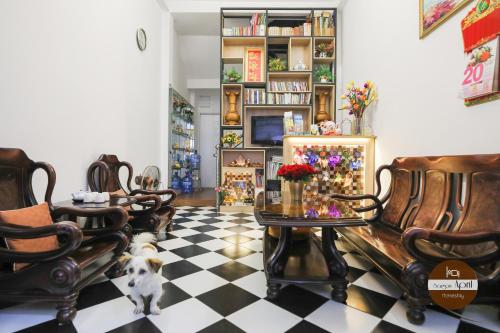 a living room with chairs and a table and a dog at Saigon April Homestay in Ho Chi Minh City