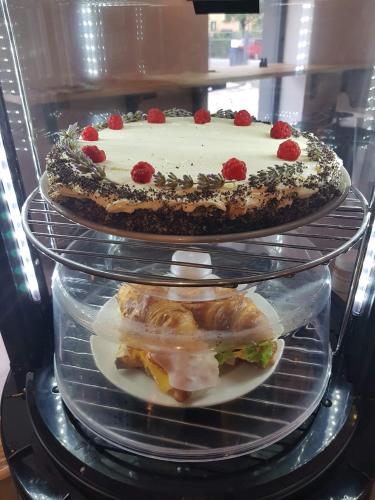 a cake on three tiers in a refrigerator at Penzion a Bistro Dílna in Třeboň