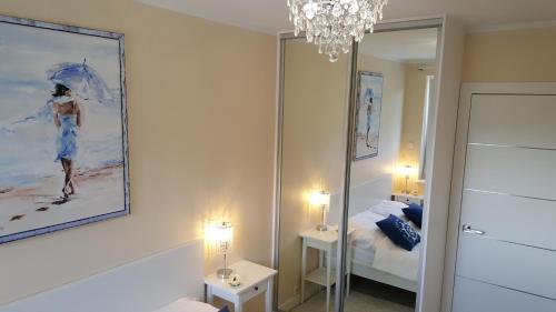 a room with a mirror and a bedroom with a bed at Z widokiem na morze in Rewal