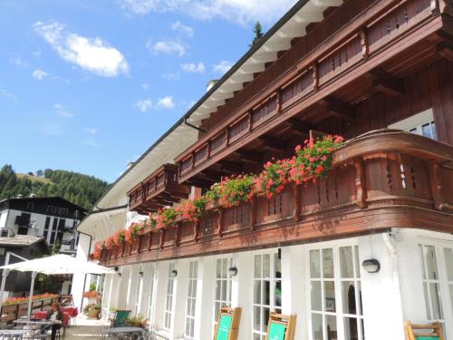 a building with flowers on the side of it at Hotel La Meridiana in Madesimo