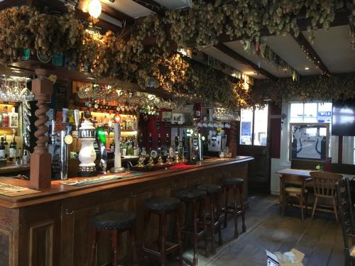 a bar with bar stools in a pub at tiger inn in Bridport