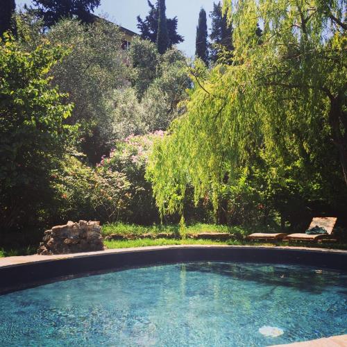 a large swimming pool in a yard with trees at Relais Rantegosa - Holiday home in Chiavari
