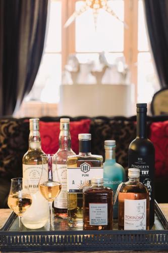 a tray with several bottles and glasses of wine at Hôtel Saint Pierre Boutique-Hôtel in Saumur