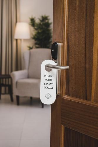 a door knob with a sticker that reads make up my room at Two Pillows Boutique Hostel in Sliema