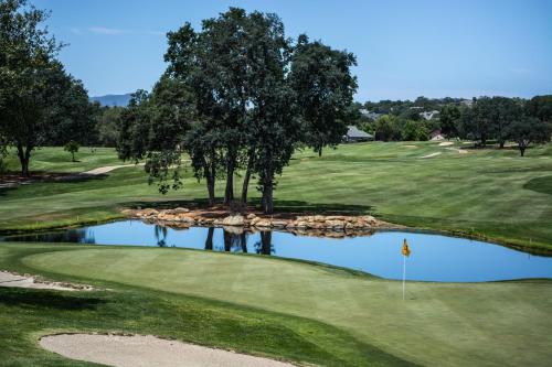 a view of a golf course with a pond at Hôtel Saint Pierre Boutique-Hôtel in Saumur