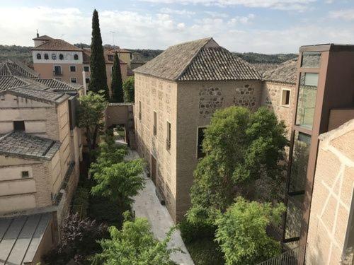 an overhead view of a city with buildings and trees at Hostal Santo Tomé in Toledo