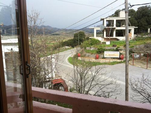 a view of a road from a balcony with a building at Dionysus House Lasithi Plateau in Magoulás