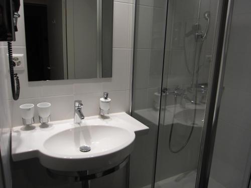 a bathroom with a sink and a shower at Kloster Kappel in Kappel am Albis