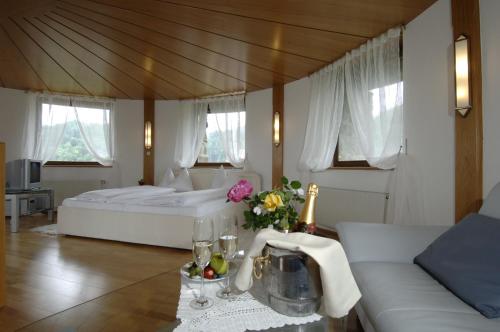 a bedroom with a large white bed and a couch at Burg Deutschlandsberg in Deutschlandsberg