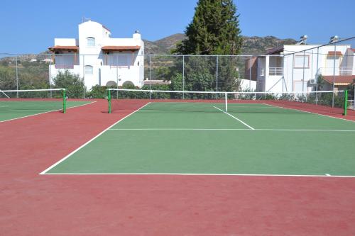 a tennis court with two tennis courts at Gennadi Grand Resort in Gennadi