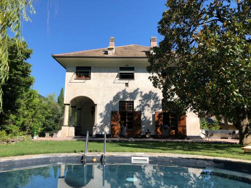 a house with a swimming pool in front of a house at Relais Rantegosa - Holiday home in Chiavari