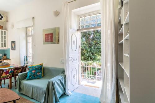 a living room with a door leading to a patio at Brand New Gem In Talbiyeh in Jerusalem