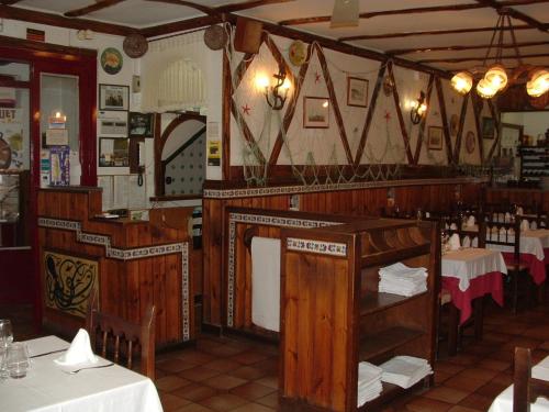 a dining room with tables and chairs in a restaurant at Hotel La Cala in Roses