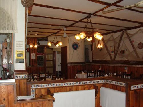 a bar in a restaurant with a large mirror at Hotel La Cala in Roses