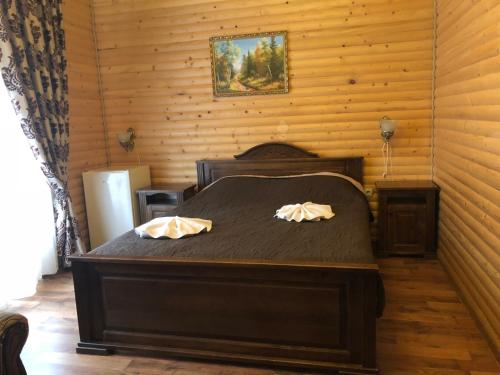 a bedroom with a bed with two pillows on it at Villa Nikoletta SPA in Bukovel