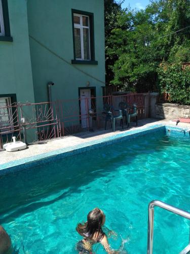 a woman in the water in a swimming pool at семеен хотел "НЕВЕН" in Momin Prohod