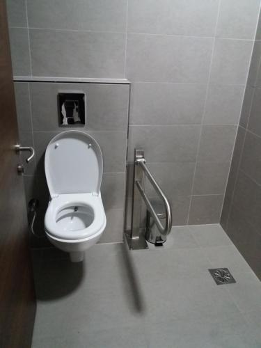 a bathroom with a toilet in a stall at City Hotel in Prizren