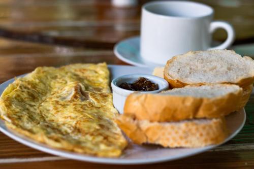 a plate of food with eggs and bread and a cup of coffee at Riviera Punta Cana Eco Travelers in Punta Cana