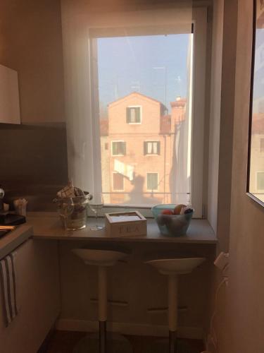 a kitchen with a window with a view of a building at Venezia Luxury Biennale Design in Venice