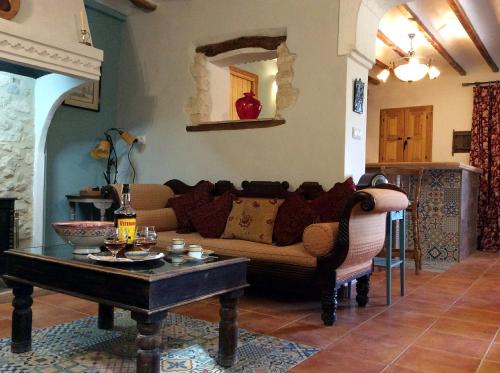 a living room with a couch and a coffee table at Los Cuatro Vientos B&B in Torre del Rico