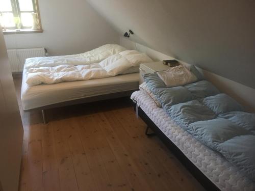 two beds sitting in a room with at 7 Bedrooms Horse Farm near Skagen in Jerup
