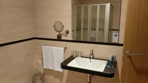 a bathroom with a sink and a mirror at Hotel Nordés in Burela de Cabo