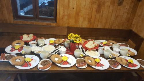 a table with plates of food and cups on it at Green House in Batumi in Batumi