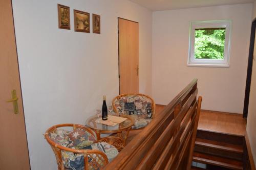 a dining room with a table and two chairs at Chata Adrian Slovak Paradise in Spišské Tomášovce