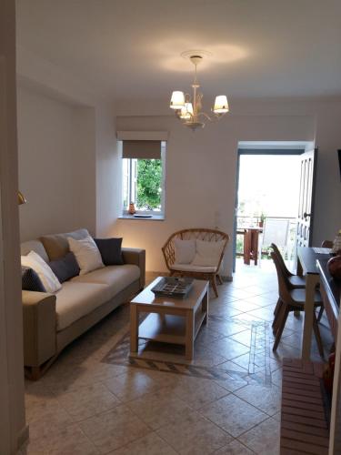 a living room with a couch and a table at Sea Colours Parga in Parga