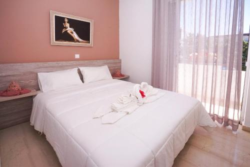 
Ένα ή περισσότερα κρεβάτια σε δωμάτιο στο Sunset Apartments & Studios

