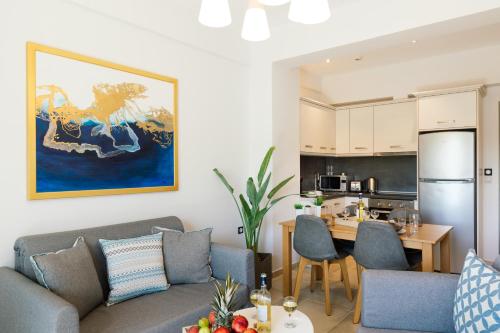 a living room with a couch and a kitchen at Belvedere Luxury Apartments & Spa in Plakias