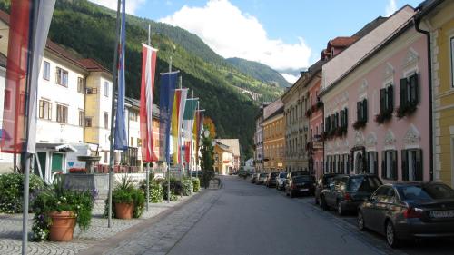a street in a town with cars parked at Haus Pleterski in Obervellach