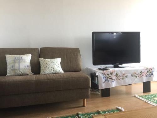 a living room with a couch and a tv on a table at Apartment Subota in Mali Lošinj