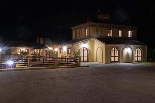 a large house at night with lights at BorgoPratole CountryHouse in Cingoli