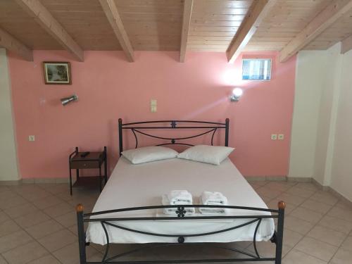 a bedroom with a bed with two shoes on it at Rania Studios in Lefkada