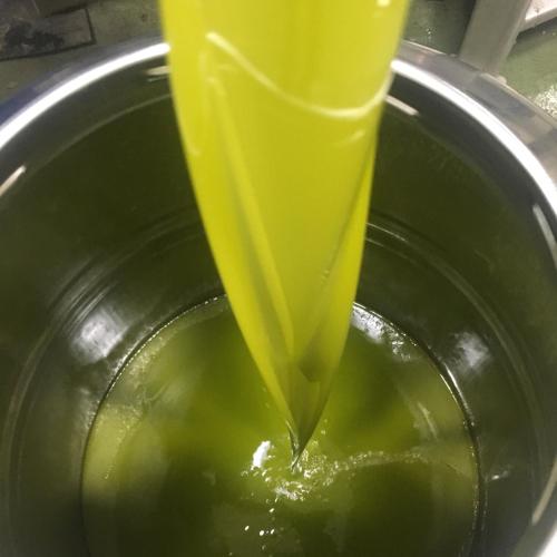 a pot of yellow liquid is being stirred at Villa Baronzola in Montevarchi