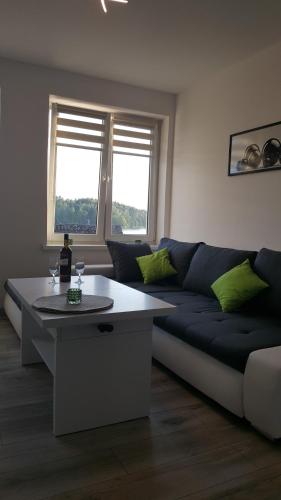 a living room with a couch and a table at Apartament ULA in Mikołajki